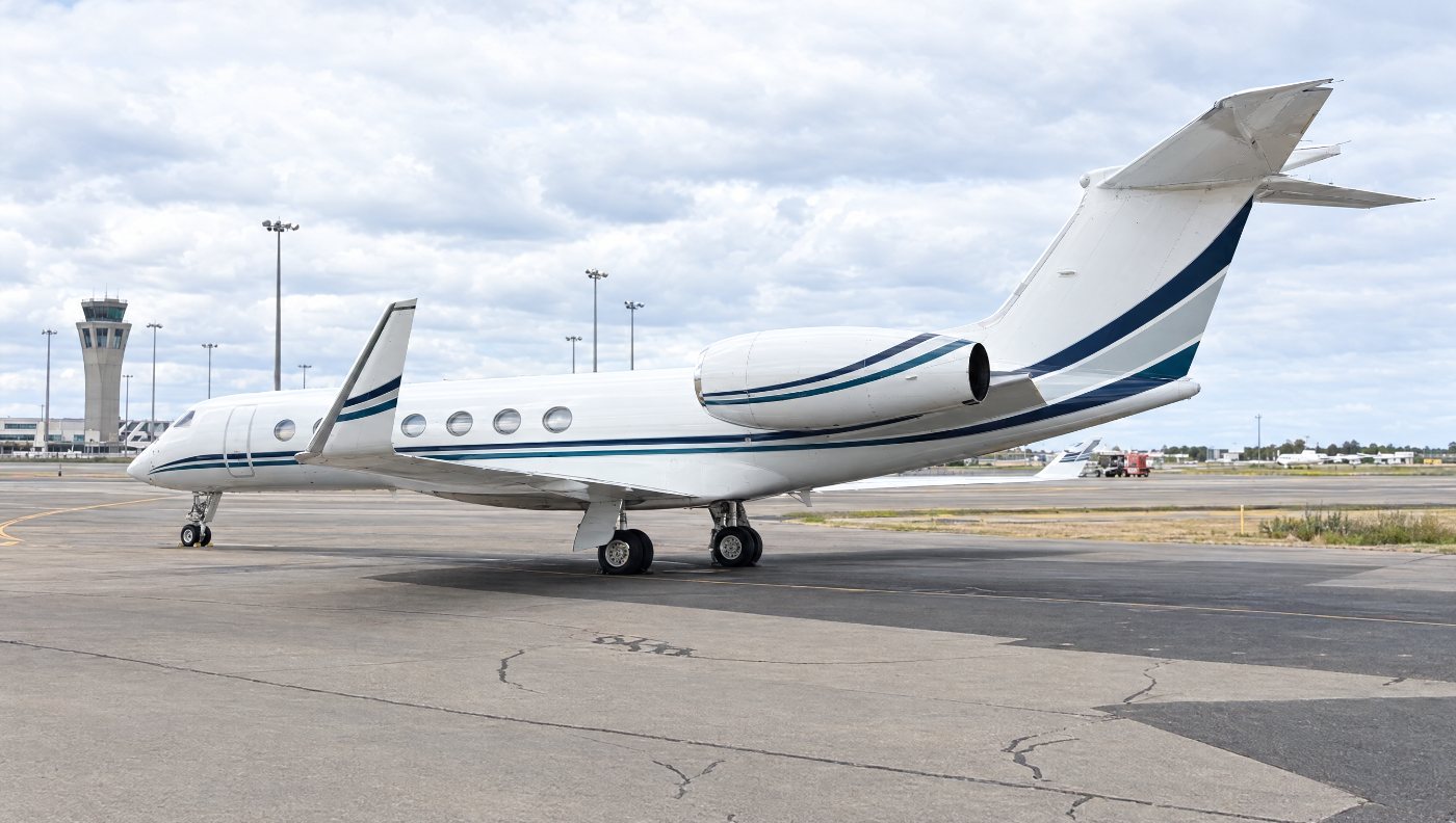 Gulfstream parked on the ramp with the control tower behind