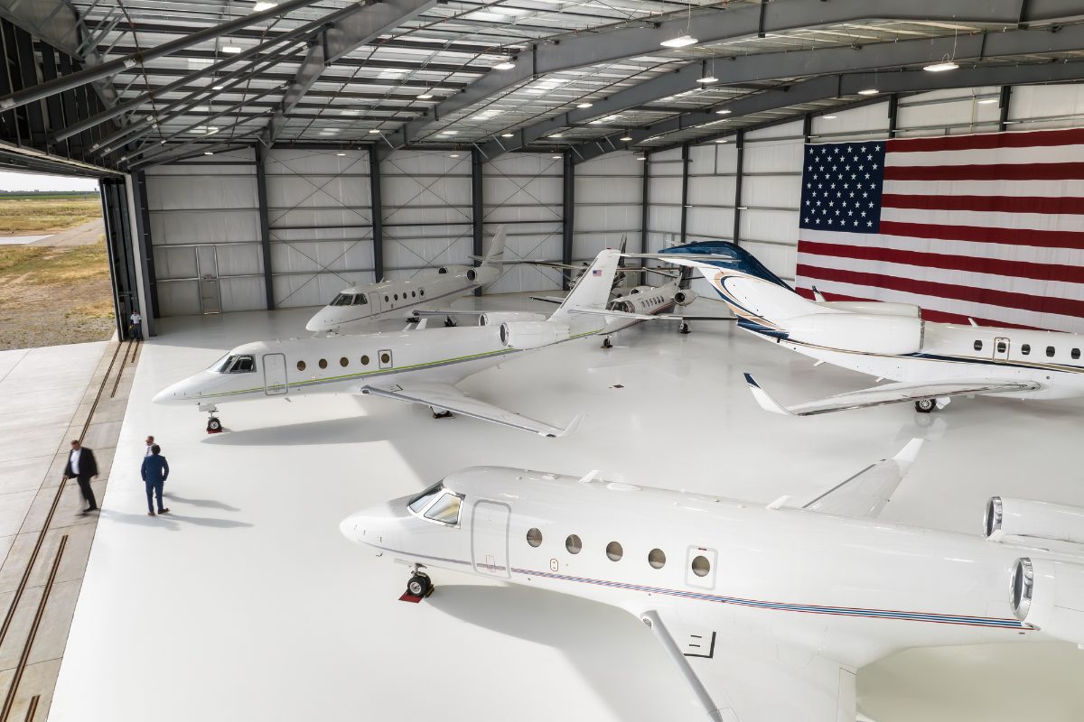 Business jets parked inside a corporate hangar